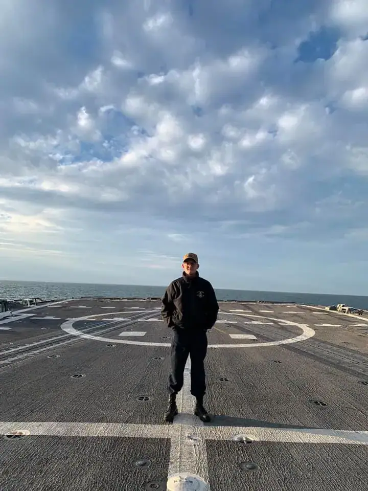 Austin Barrett standing on a Navy ship's flight deck